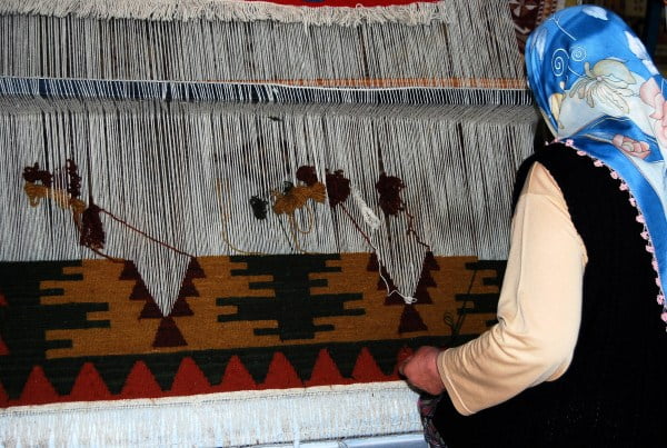 Woman making Turkish carpet